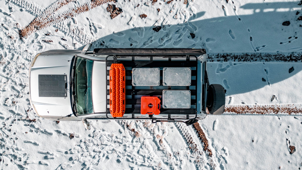 AluBox aluminum cases, overhead view of three cases on a truck roof rack in snow