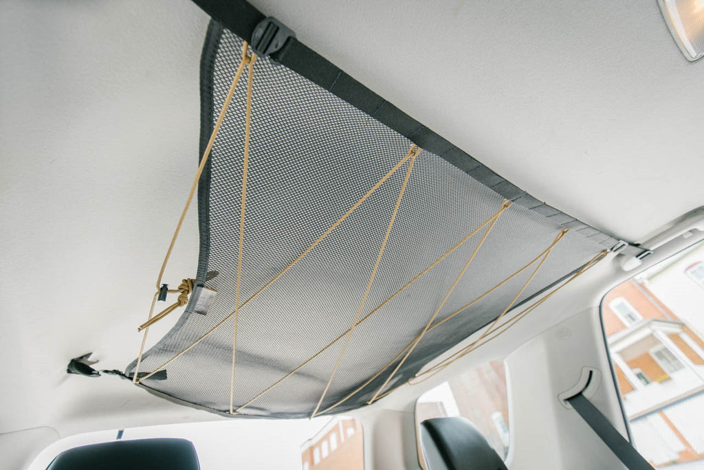 The empty 4Runner attic from a low angle, corners clipped to the grab handles