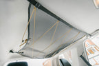 The empty 4Runner attic from a low angle, corners clipped to the grab handles