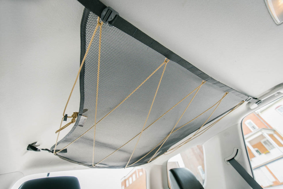 The empty 4Runner attic from a low angle, corners clipped to the grab handles