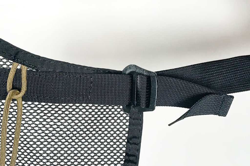 Close on the webbing tab, G-hook and paracord lacing at one corner