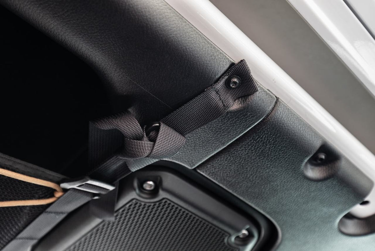 The JLU attic strap bolted in at an existing roll bar mount