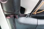 Close on a buckle where the JLU attic meets the roll bar
