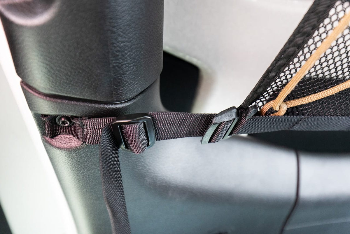 Close on a buckle where the JLU attic meets the roll bar