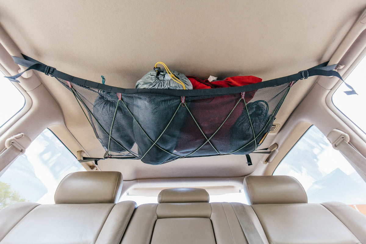 The attic over the rear seats of a Land Cruiser, holding a jacket and soft gear