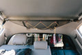 The attic in a Tacoma crew cab, running across the headliner behind the front seats with gear in it