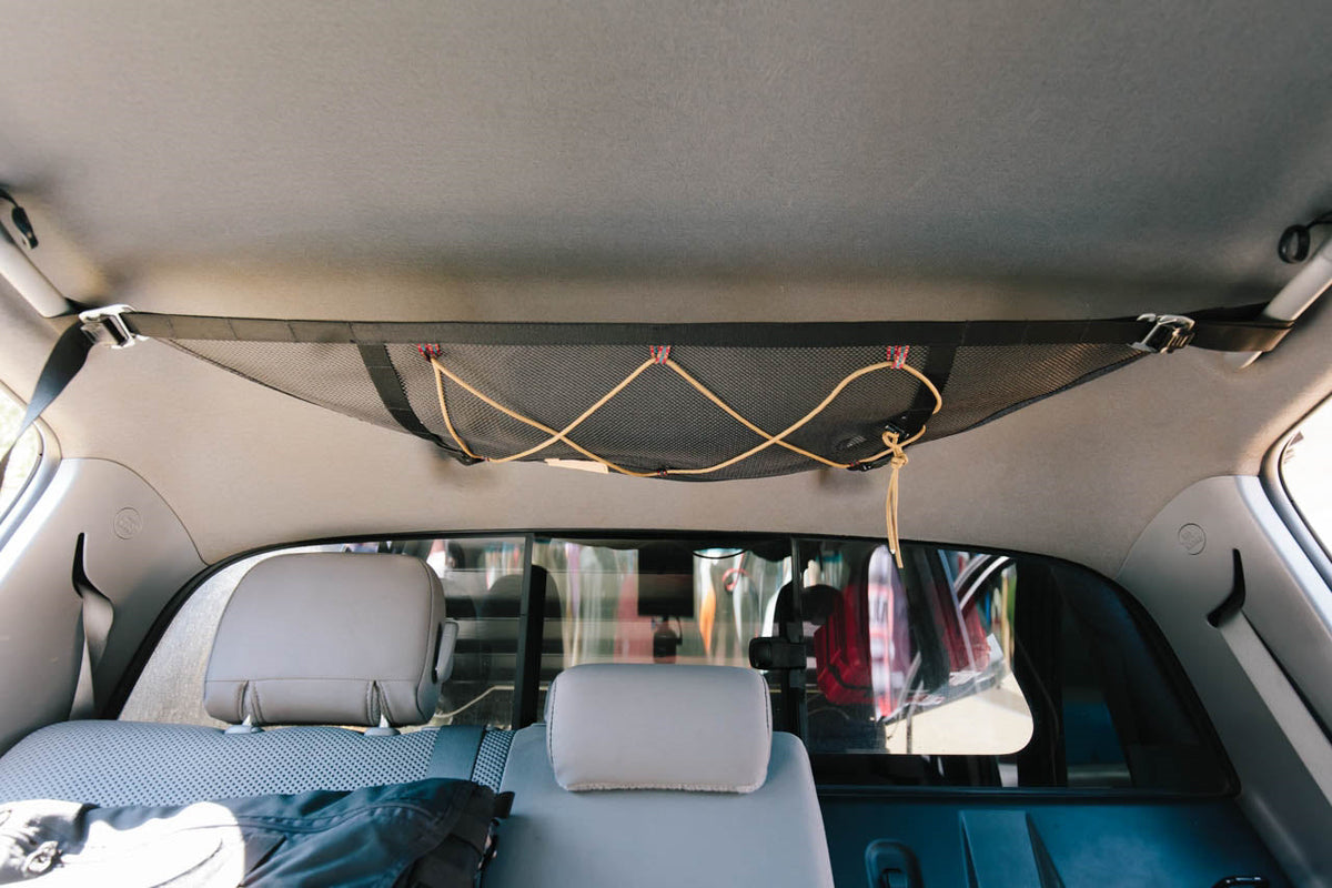The attic in a Tacoma crew cab, running across the headliner behind the front seats with gear in it