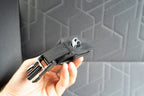 The mounting clip and buckle in hand, ready to fit