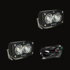 A pair of S2 Pro pods with clear spot lenses, shown with the wiring harness