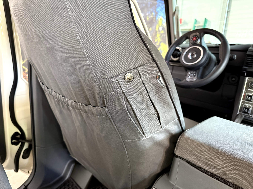 Escape Gear canvas seat covers, Ineos Grenadier, close-up of the Grey seat back pocket with snap closure