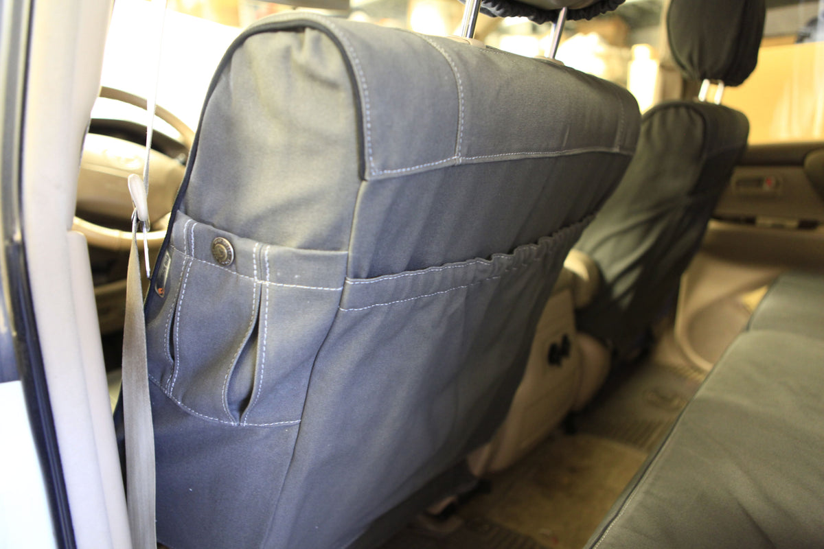 Escape Gear canvas seat covers, Land Cruiser 100 Series, close-up of the Grey seat back pocket with snap tab