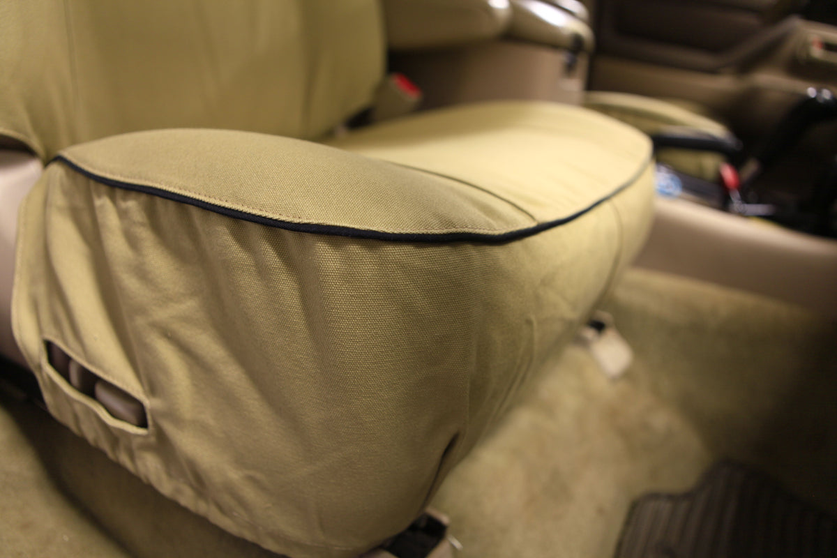 Escape Gear canvas seat covers, Land Cruiser 100 Series, Light Khaki front seat base close-up with black piping