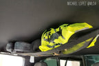 The Tacoma attic holding a hi-vis jacket and hats, customer photo