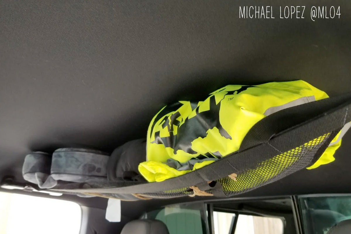 The Tacoma attic holding a hi-vis jacket and hats, customer photo