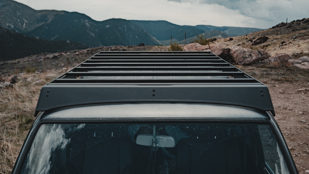 Mineral rack crossbars and wind fairing seen over the 60 Series windshield