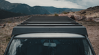 Mineral rack crossbars and wind fairing seen over the 60 Series windshield