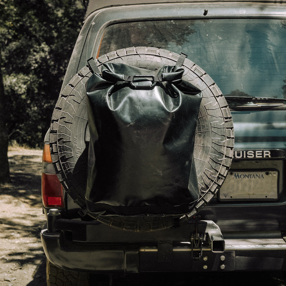 The tire bag strapped to the spare wheel of a Land Cruiser