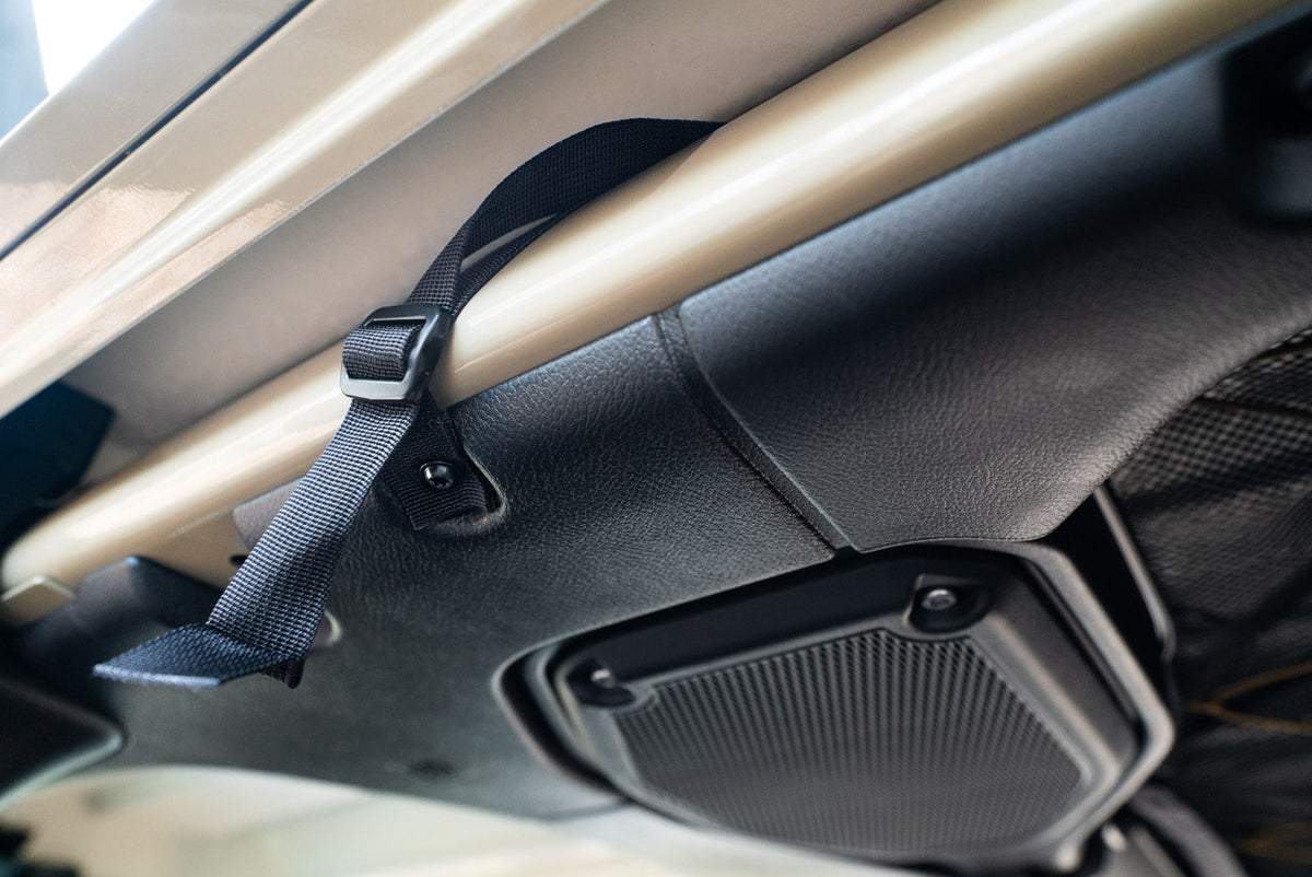 The Gladiator attic strap running along the roll bar to its mount
