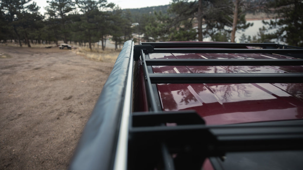 Awning bag on Sherpa awning mounts along a red 4Runner rack