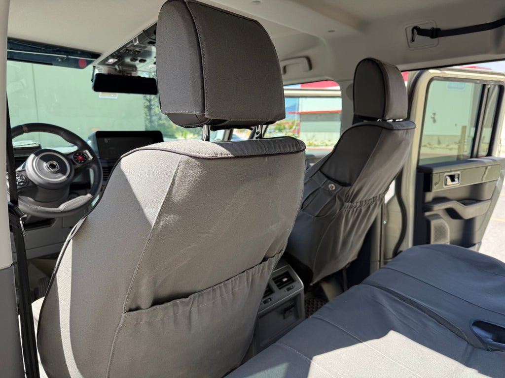 Escape Gear canvas seat covers, Ineos Grenadier, Grey front seat backs with map pockets, seen from the rear seat