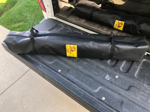 Eezi-Awn K9 Fold A Chair, two chairs in black carry bags on a pickup tailgate