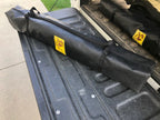 Eezi-Awn K9 Fold A Chair in its black carry bag on a pickup tailgate, angled view
