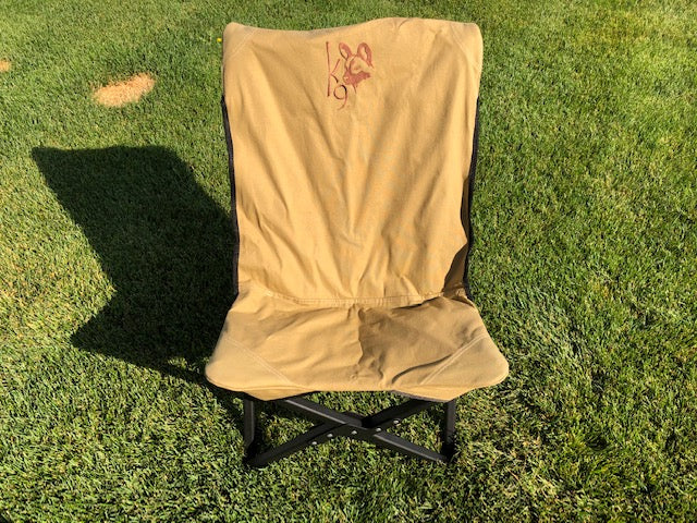 Eezi-Awn K9 Fold A Chair in Beige set up on grass, front view with embroidered K9 logo