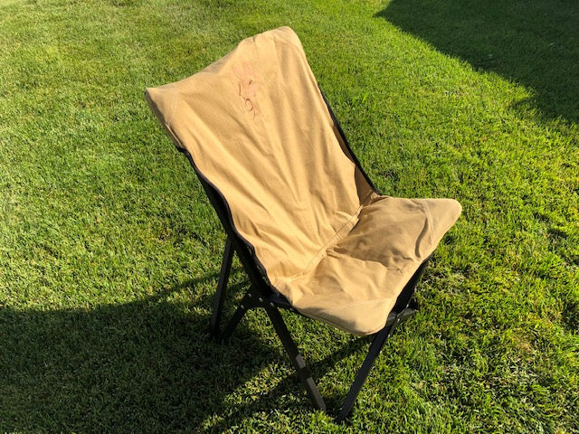 Eezi-Awn K9 Fold A Chair in Beige on grass, three-quarter view from above