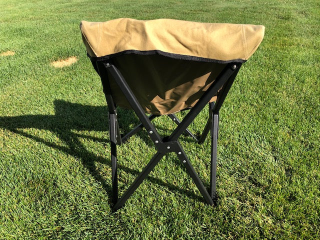 Eezi-Awn K9 Fold A Chair in Beige, rear view showing the black X-frame on grass