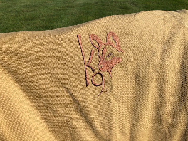Eezi-Awn K9 Fold A Chair, close-up of the embroidered K9 logo on the Beige canvas back