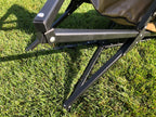 Eezi-Awn K9 Fold A Chair, close-up of the black frame joints and legs on grass