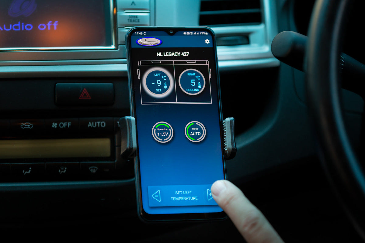 National Luna 35L dual zone fridge freezer, phone in a dash mount showing the NL Connect app with both zone temperatures