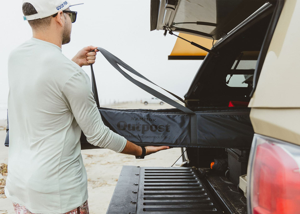 Pulling the Outpost travel bag out of a truck bed