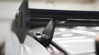 Oxford mounting bracket bolted to the 100 Series roof under a crossbar