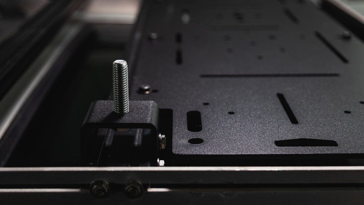 Adapt Plate holes and an antenna stud bracket on a crossbar