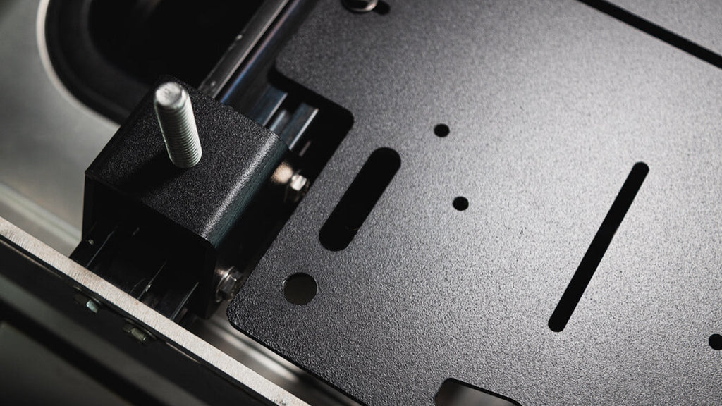 Adapt Plate beside an antenna bracket, close-up