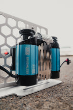 ARB Brushless twin compressor on a honeycomb mounting plate outside, blue motor housings and the ARB logo up close (plate not included)