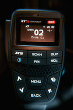 The XRS Connect handset up close, its screen showing GMRS channel 02 in zone 01, scan and menu keys below