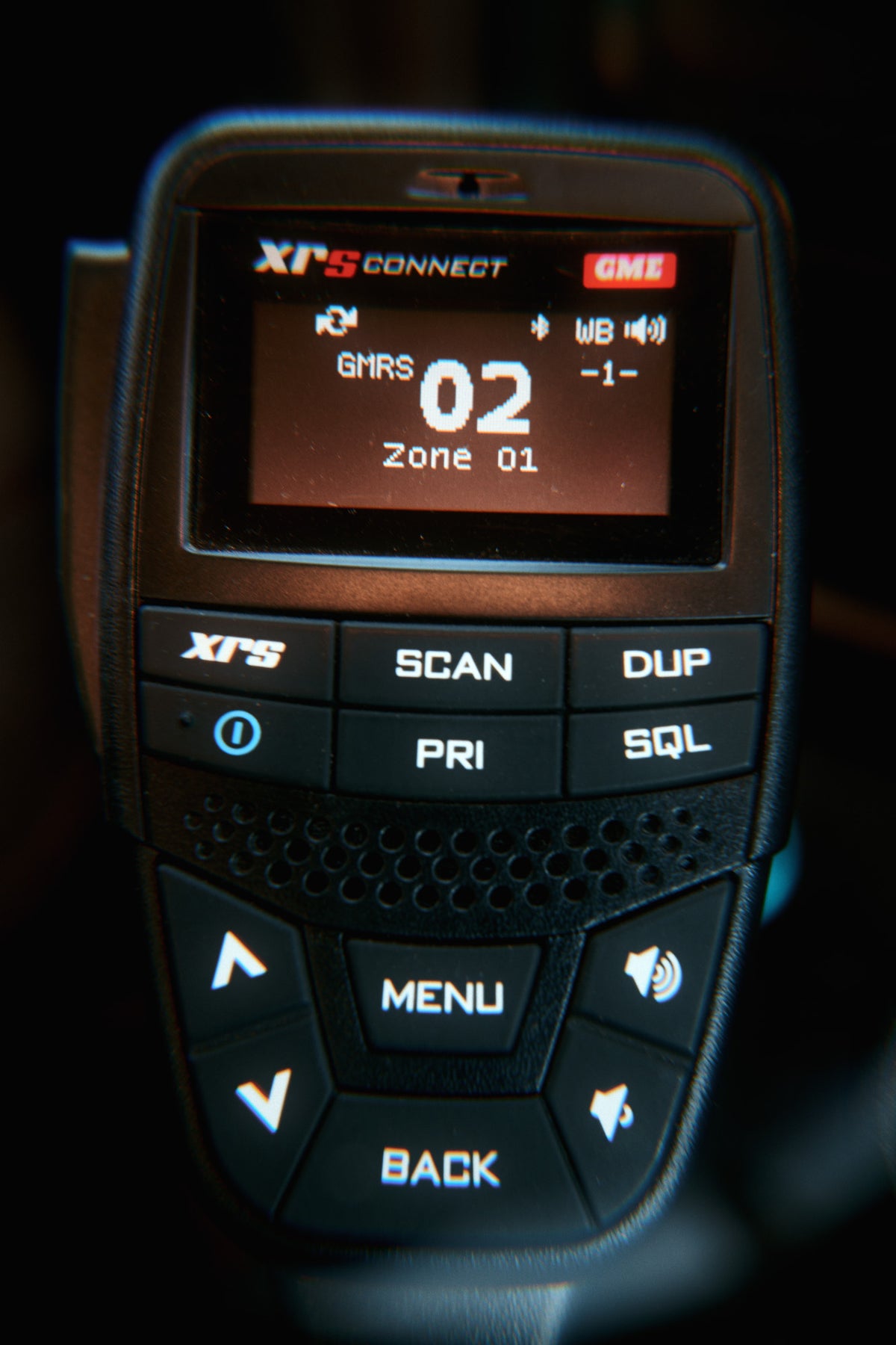 The XRS Connect handset up close, its screen showing GMRS channel 02 in zone 01, scan and menu keys below