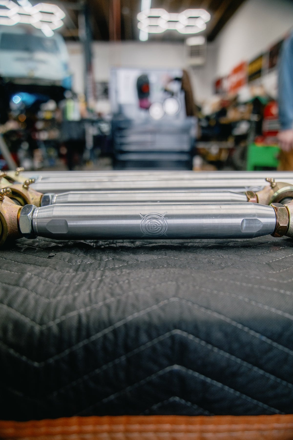 An Overland Custom Design upper control arm on a moving blanket, the OCD logo engraved into the 7075 aluminum