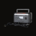 The 300W power station with cables plugged into the outputs
