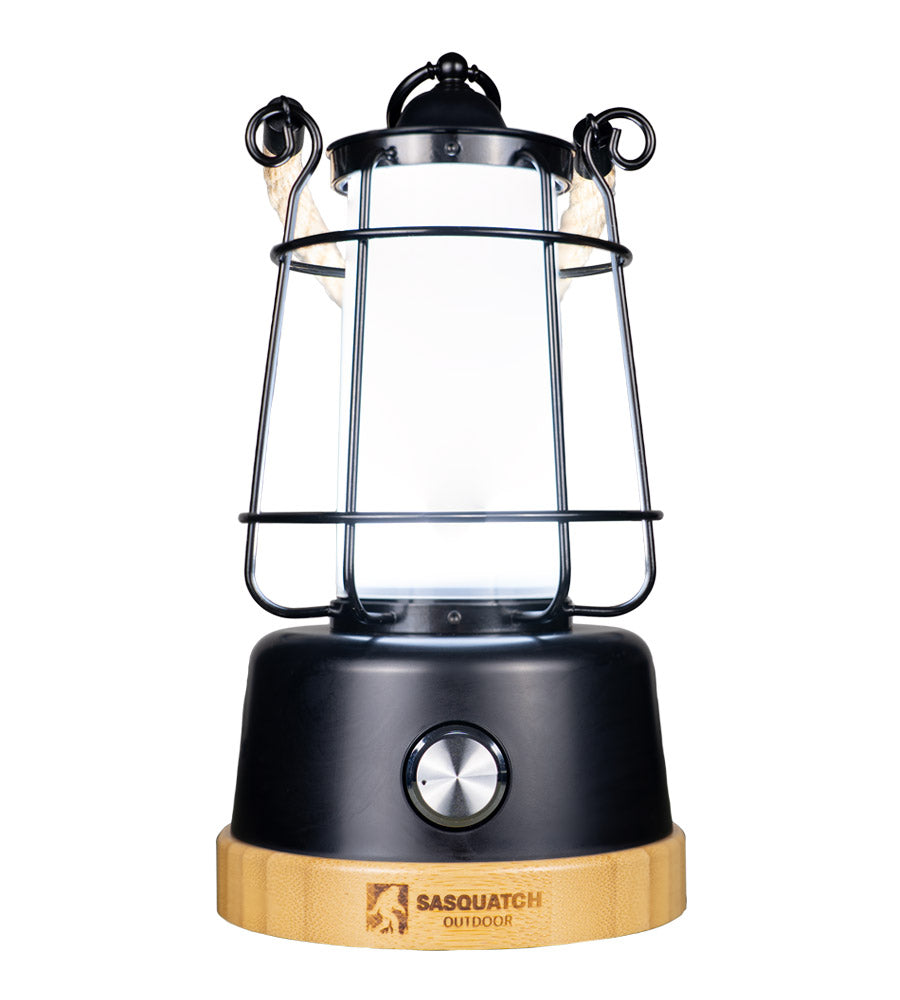The rope lantern from a high angle, hemp rope handle looped over the top