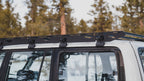 La Sal sideplate running the length of a white 80 Series roof, gutter mounts at each crossbar